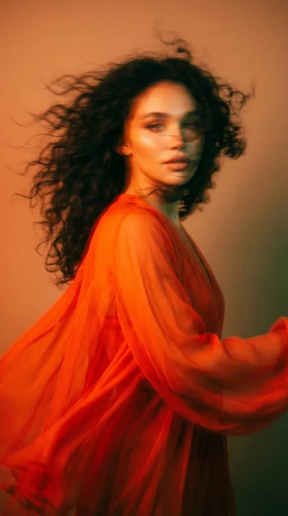 A high-fashion editorial portrait of a young woman with long…